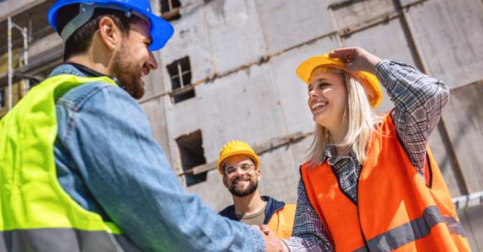 Construction workers shaking hands