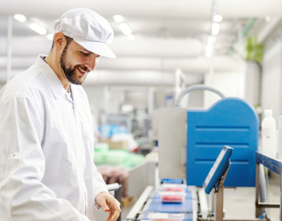 Smiling meat factory worker packing